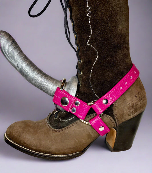 brown suede boot wearing a magenta leather boot strapon harness