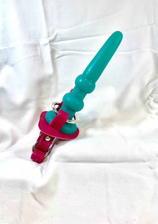 magenta leather hand strapon with a turqoise dildo