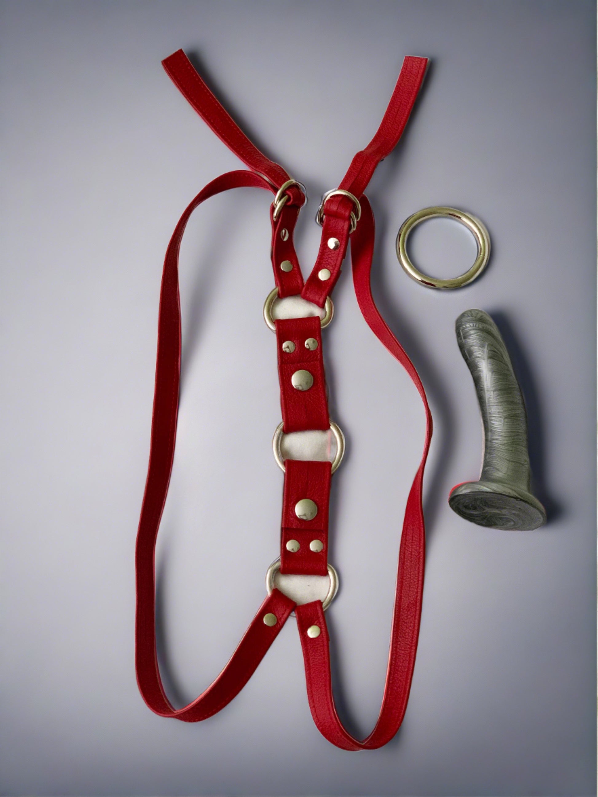 red leather thigh strapon harness with  nickel plated o'ring and silver dildo